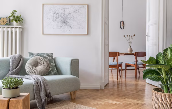 cozy-creative-composition-stylish-living-room-interior-design-with-frame-green-sofa-wooden-furniture-plants-accessories-white-walls-parquet-floor_431307-2090